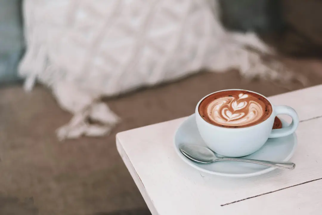 a warm cup of coffee with latte art at a doodle café in Windsor